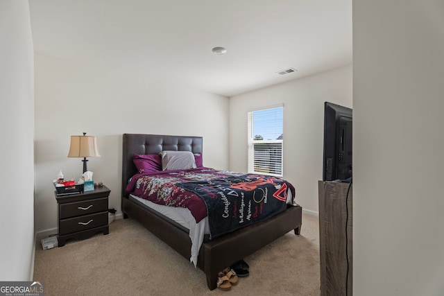 bedroom featuring light carpet