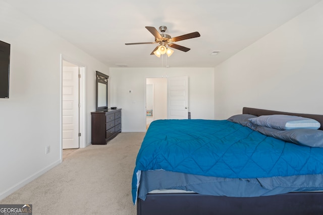 bedroom with ceiling fan and light carpet