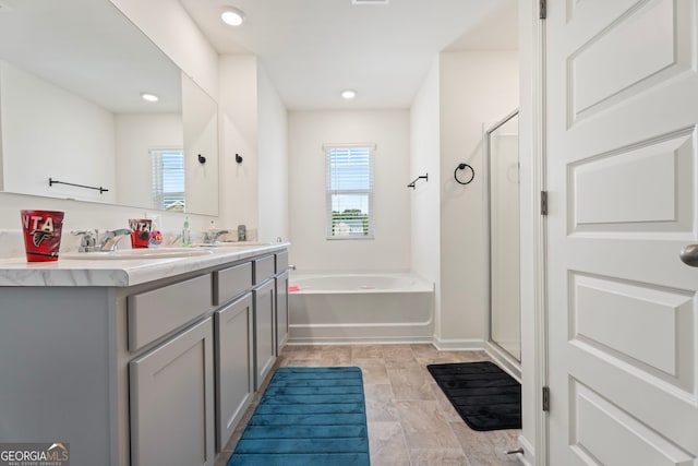 bathroom featuring vanity and separate shower and tub