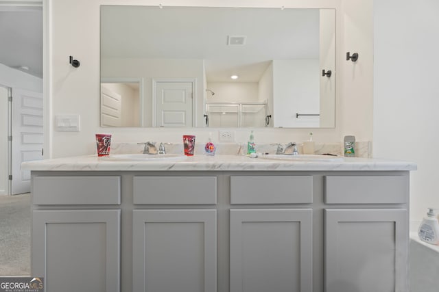 bathroom featuring vanity and a shower with door