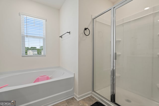 bathroom featuring separate shower and tub