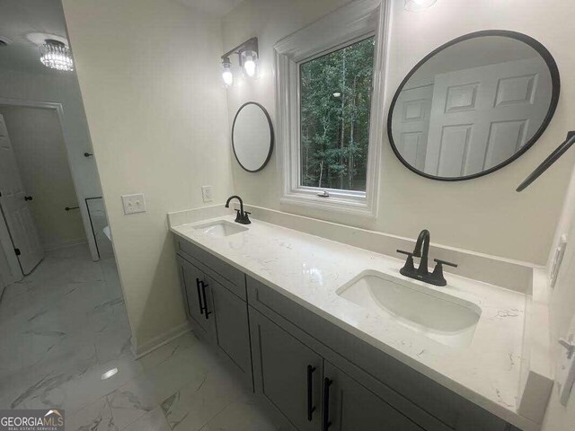 bathroom with double vanity and tile patterned floors