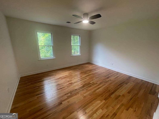 spare room with ceiling fan and hardwood / wood-style flooring