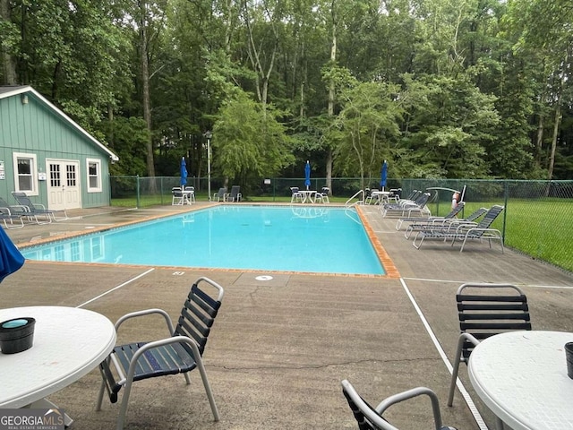 view of swimming pool featuring a patio area