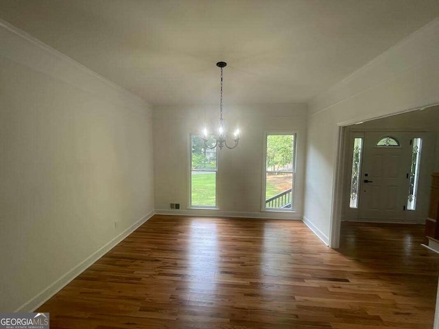 unfurnished dining area with wood-type flooring and an inviting chandelier