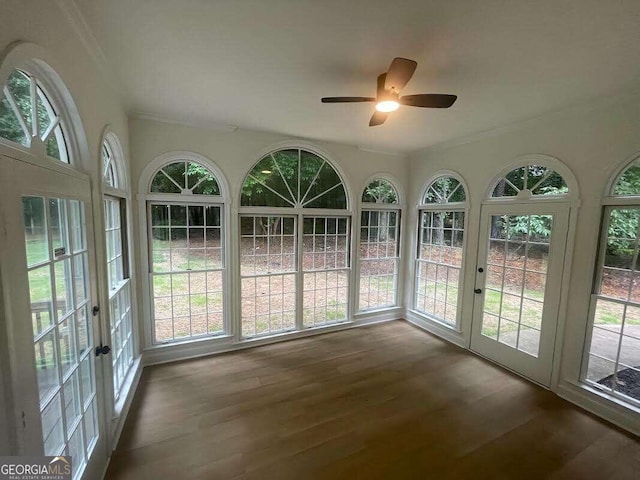 unfurnished sunroom with ceiling fan and french doors