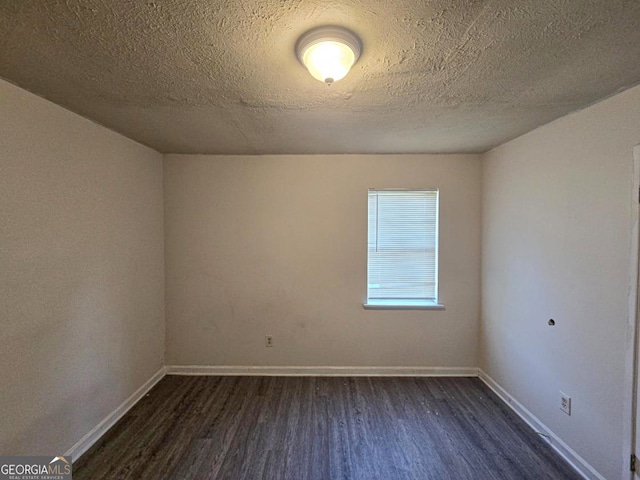 unfurnished room with a textured ceiling and hardwood / wood-style flooring