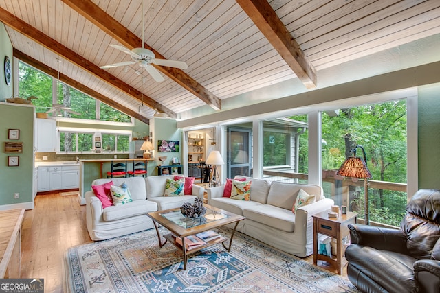 sunroom / solarium featuring wood ceiling, ceiling fan, sink, and lofted ceiling with beams