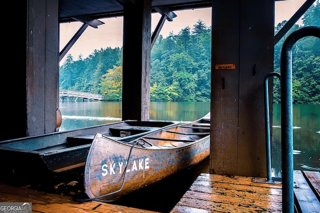 interior space featuring multiple windows, hardwood / wood-style floors, and a water view