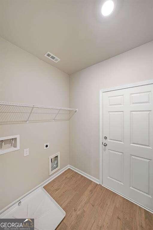 laundry area featuring electric dryer hookup, wood-type flooring, and hookup for a washing machine