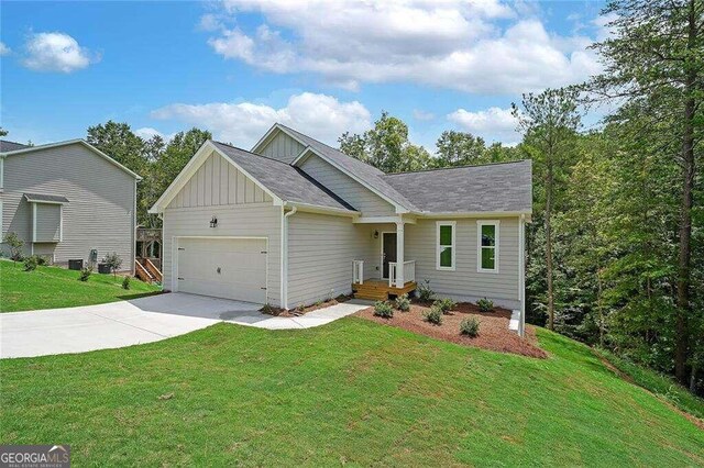 view of front of home with a garage and a front yard