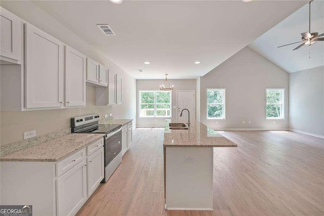 kitchen with white cabinets, stainless steel electric stove, ceiling fan with notable chandelier, and light hardwood / wood-style flooring