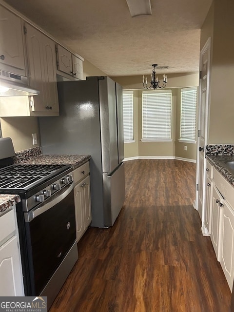 kitchen with white cabinetry, dark hardwood / wood-style floors, an inviting chandelier, and gas range oven