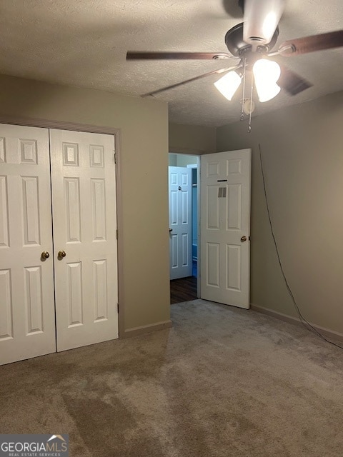 unfurnished bedroom with ceiling fan, a closet, and carpet flooring