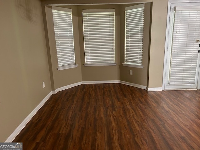 spare room featuring dark hardwood / wood-style flooring