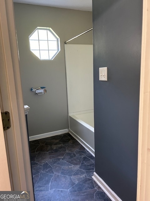 bathroom with shower / washtub combination and tile patterned flooring