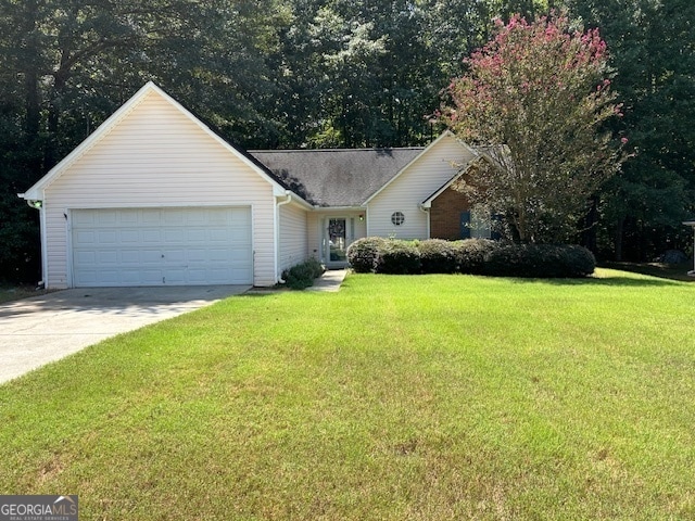 ranch-style house featuring a garage and a front yard