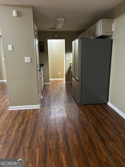 kitchen featuring stainless steel refrigerator and dark hardwood / wood-style floors