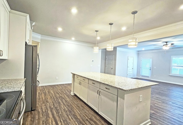 kitchen with stainless steel appliances, dark wood-type flooring, light stone countertops, and a center island