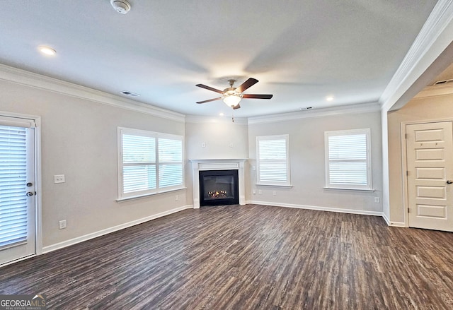 unfurnished living room with dark wood-style floors, ornamental molding, and baseboards