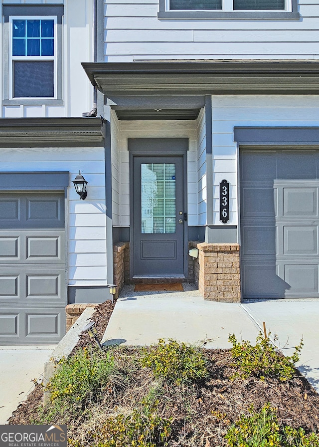 view of exterior entry featuring a garage