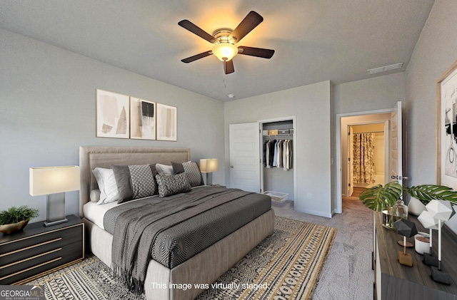 carpeted bedroom with a ceiling fan, a walk in closet, a closet, and visible vents