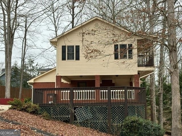 back of property featuring a wooden deck