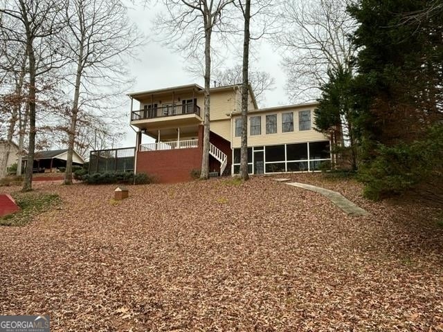 rear view of house featuring a sunroom