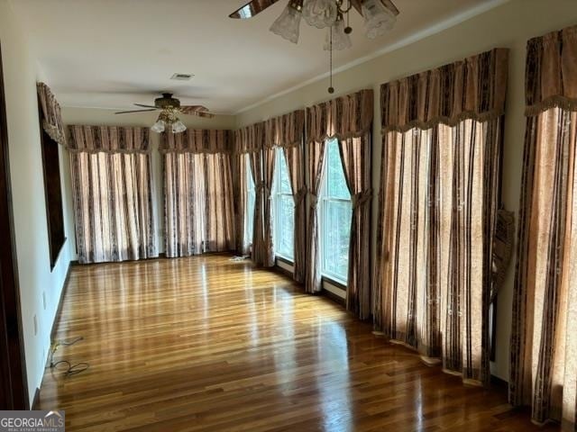 spare room with ceiling fan and hardwood / wood-style flooring