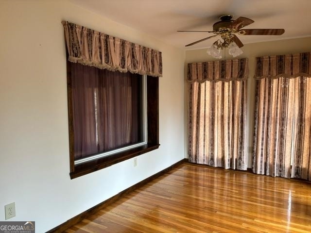 spare room featuring hardwood / wood-style flooring and ceiling fan