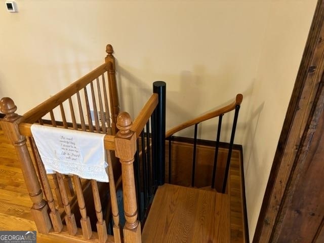 staircase with hardwood / wood-style flooring