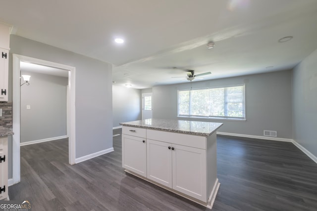 kitchen with white cabinets, dark hardwood / wood-style flooring, and ceiling fan