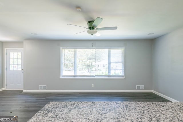 unfurnished room with dark hardwood / wood-style floors and ceiling fan