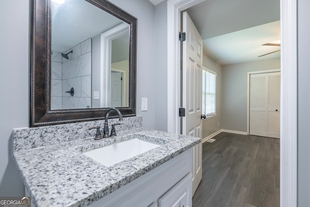 bathroom featuring hardwood / wood-style floors, vanity, and ceiling fan