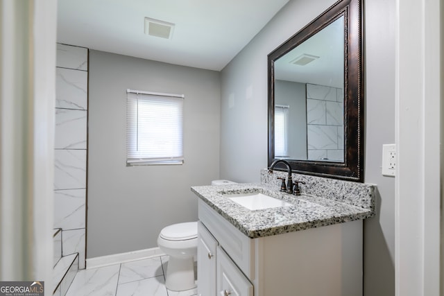 bathroom with vanity, tile patterned flooring, and toilet