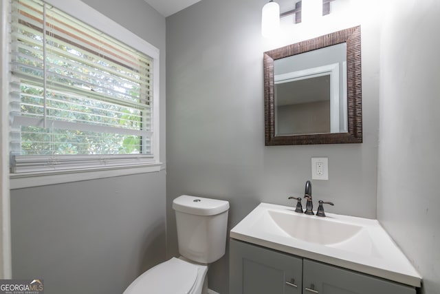 bathroom featuring toilet and vanity