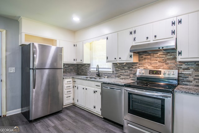 kitchen with white cabinetry, dark hardwood / wood-style flooring, stainless steel appliances, decorative backsplash, and stone counters