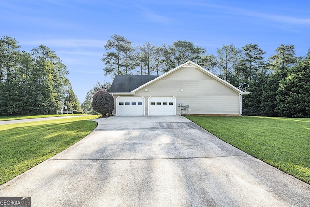 view of side of property with a garage and a yard