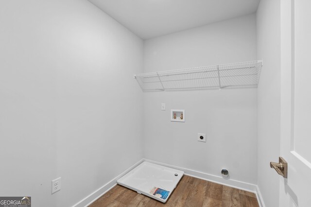 clothes washing area with hookup for a washing machine, hardwood / wood-style flooring, and hookup for an electric dryer