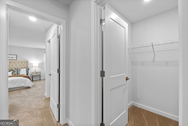 hallway with light colored carpet