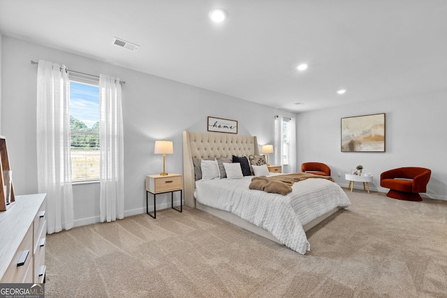 bedroom featuring light carpet