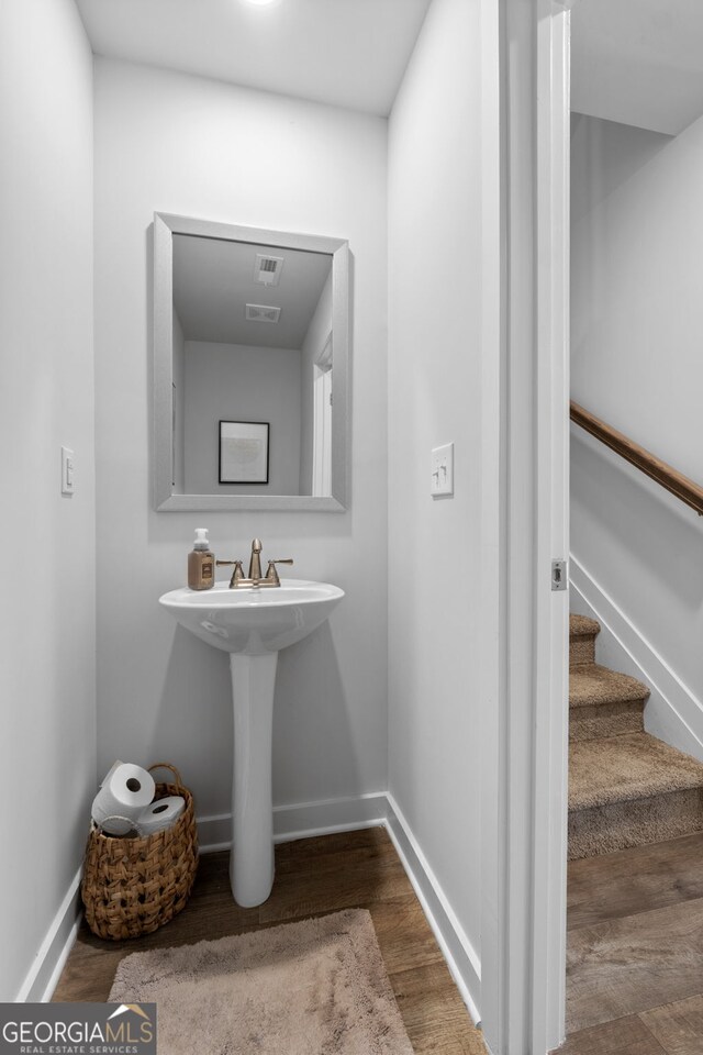 bathroom with hardwood / wood-style floors