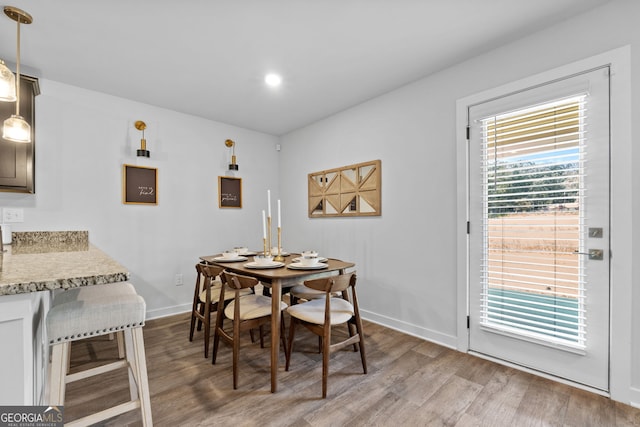 dining space with light hardwood / wood-style flooring