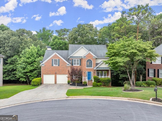 view of front of property with a garage and a front lawn