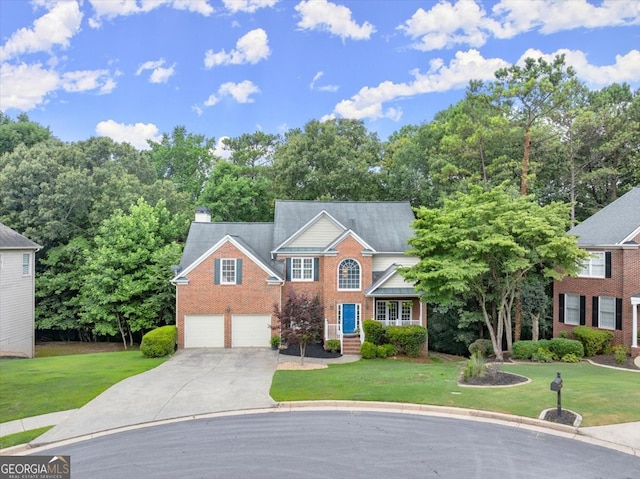 view of front of property with a garage and a front yard