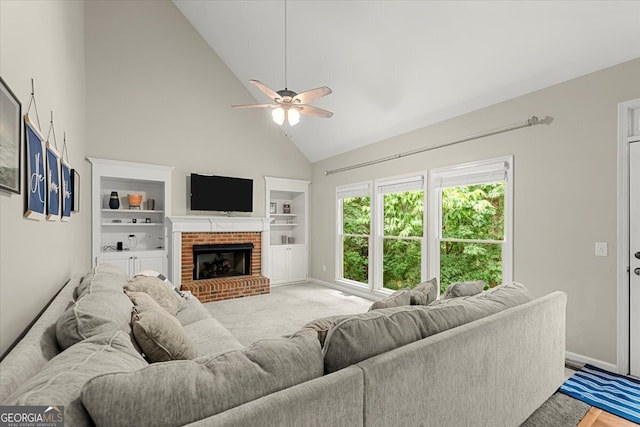 living room with built in features, a brick fireplace, ceiling fan, and high vaulted ceiling