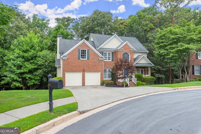 view of front of house with a garage and a front lawn