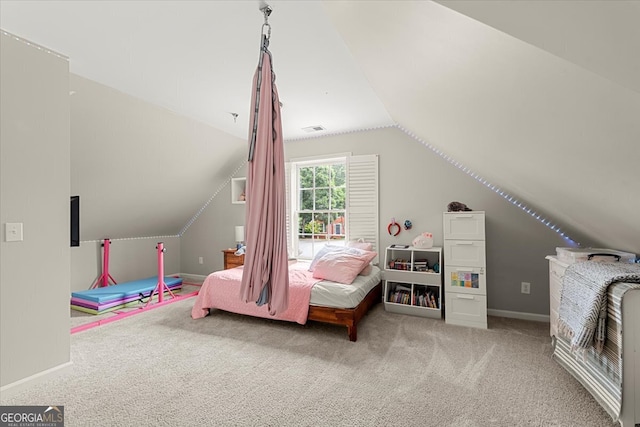 carpeted bedroom with lofted ceiling