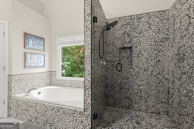 bathroom featuring independent shower and bath and tile patterned flooring