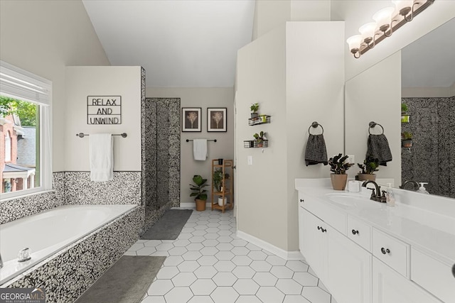 bathroom featuring vanity, tile patterned flooring, tiled bath, and high vaulted ceiling